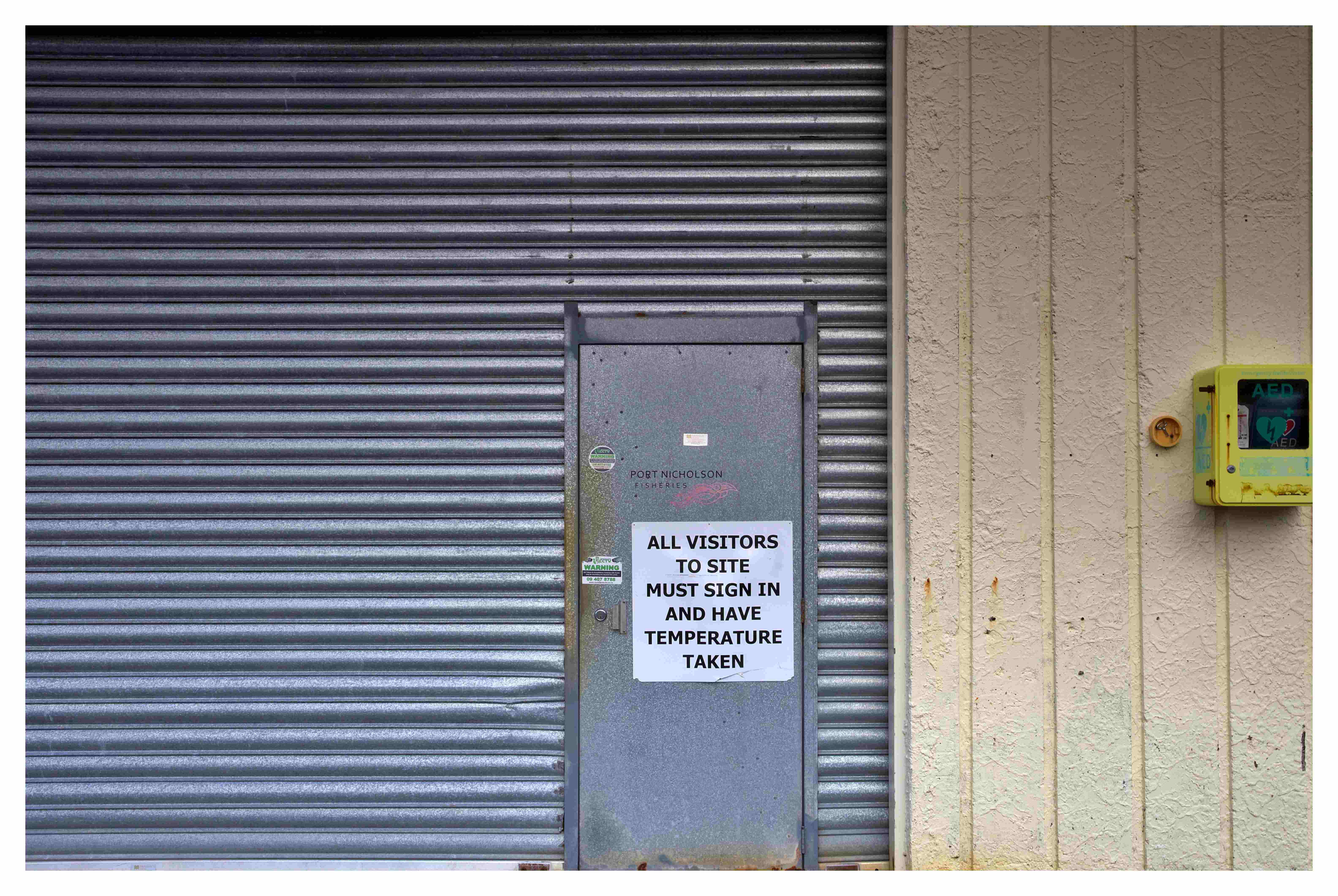 Industrial metal roller door and sign